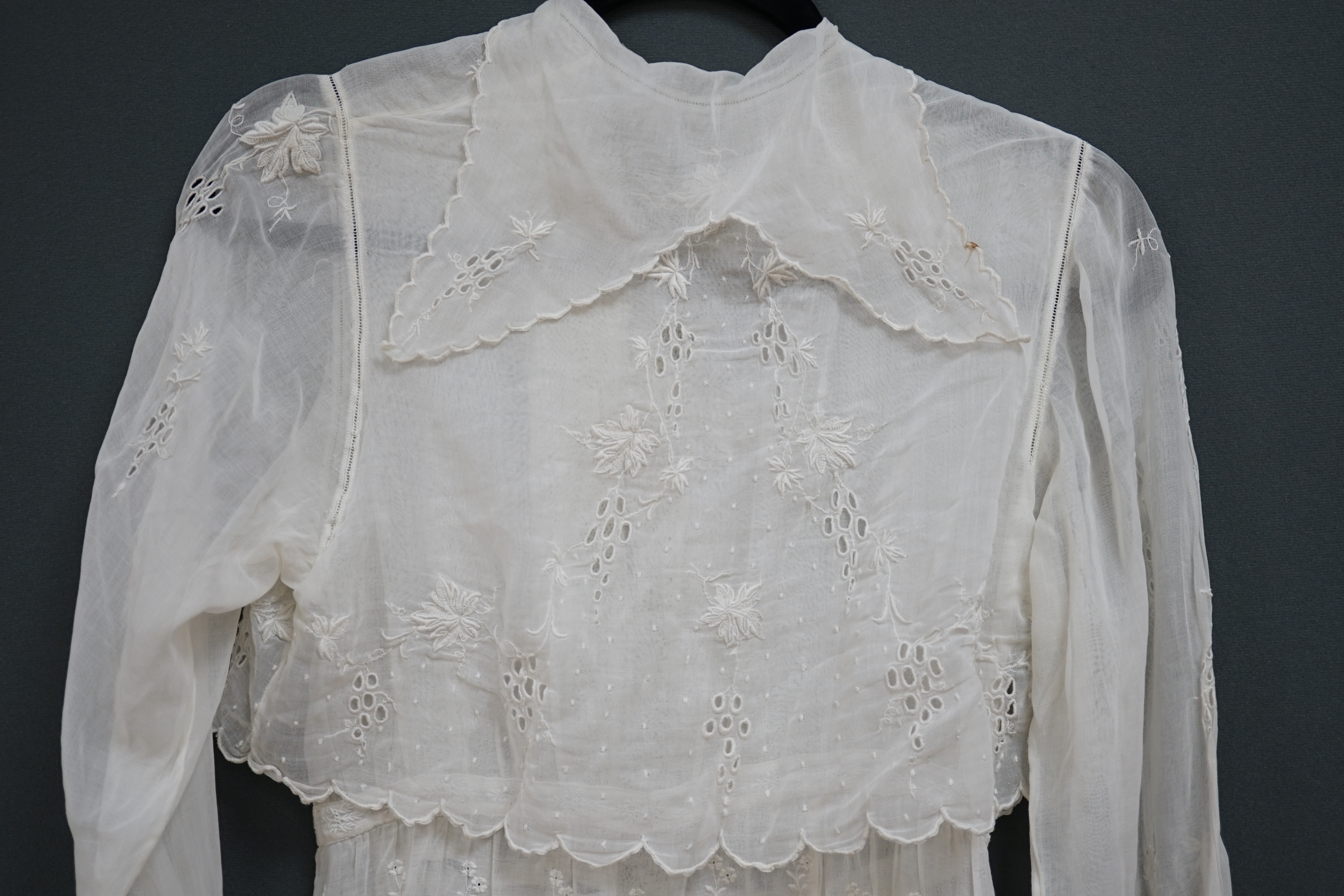 An early Edwardian fine lawn ladies hand made and embroidered crochet dress, embroidered with a white worked skirt, cuffs and lower waist and Irish crochet bodice insertions, with novelty detailing of a faux jacket front